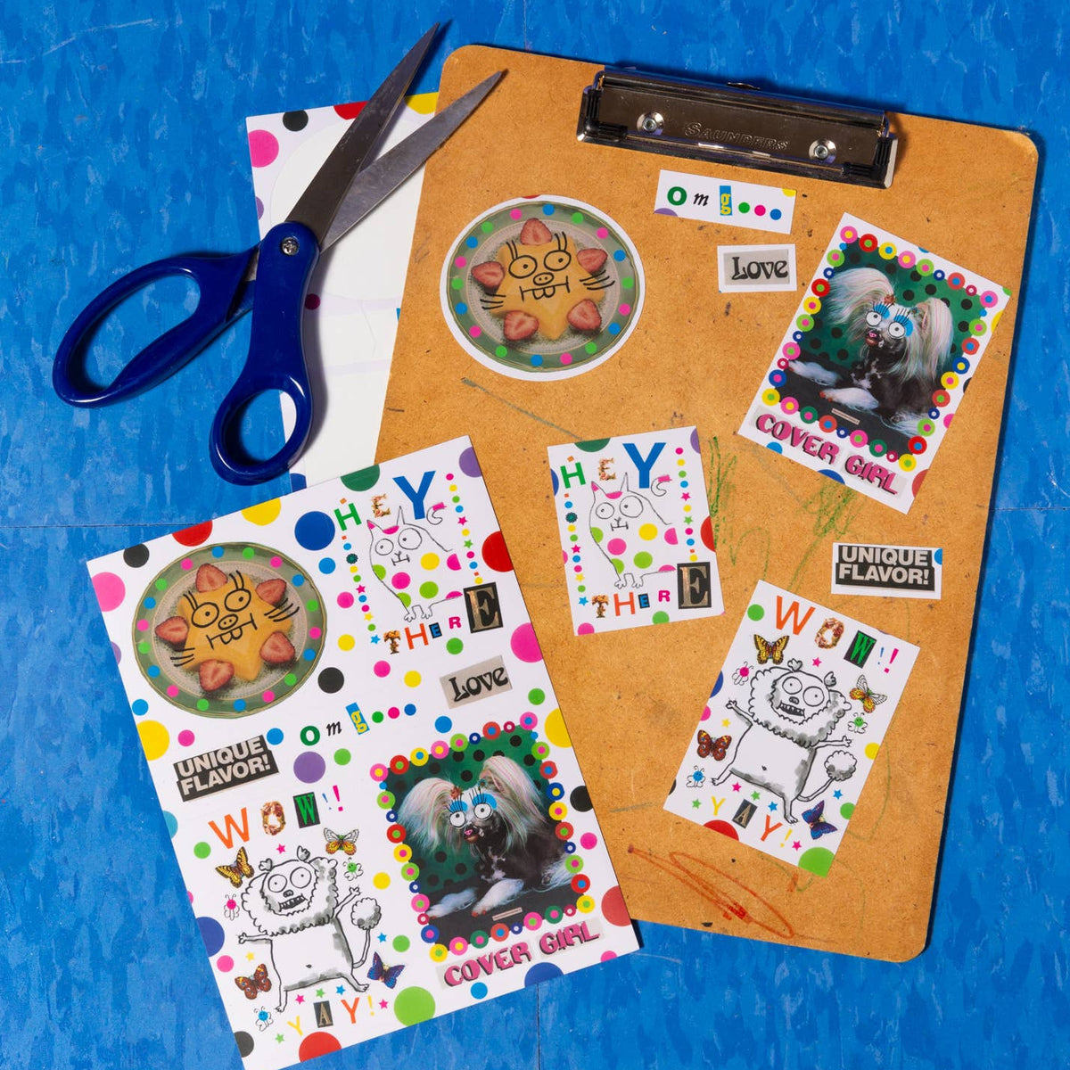 Colorful stickers on a clipboard with a pair of scissors on a blue background