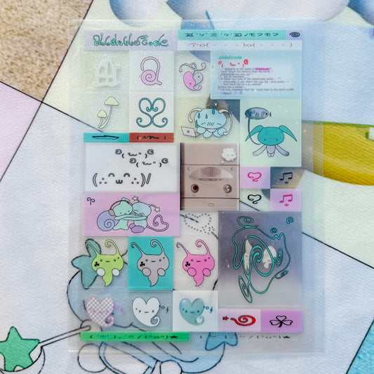 A clear plastic sleeve containing a sheet of pastel decorative stickers with cute cartoon motifs, placed on a patterned surface.